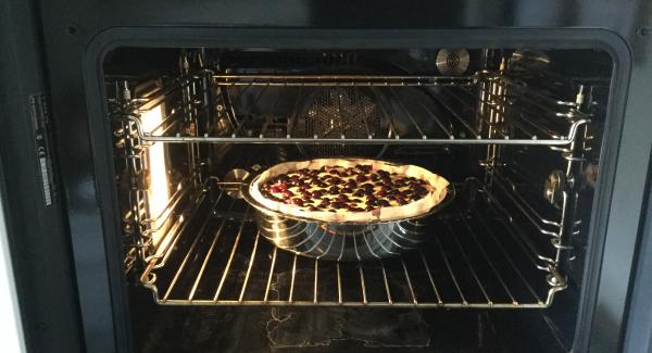 Und Den Backofen auf 180°C vorheizen. Den vorbereiteten Kuchen aus der Kühle nehmen und den Guss darübergiessen. Durch leichtes schwenken auf dem Boden gleichmässig verteilen. Das ganze für ca. 45 Minuten auf der unteren Rille im Ofen backen. Holzspiesstest: Spiess in den Kuchen stecken, es sollte keine Gussresten am Holz kleben bleiben. Herausnehmen und etwa 15 Minuten abkühlen lassen, dann mit Puderzucker bestäuben. In Portionen teilen und mit einer Rahmrosette und 2 Heidelbeeren ausgarniert servieren.