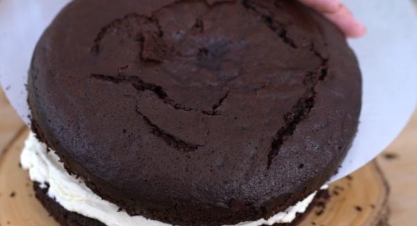 Den abgekühlten Schokoladenkuchen vorsichtig aufscheiden.
Anschließend die zwei hälften auseinander machen.
Die Milchcreme gleichmäßig auf den Kuchen verteilen.
Den Deckel des Kochen wieder draufsetzen.