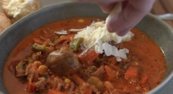 Frischen Parmesan und Basilikum über die Suppe geben.