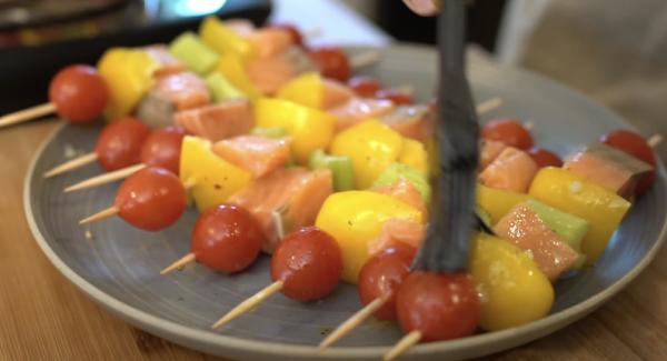 In der Zwischenzeit die Spieße mit der Marinade einpinseln.