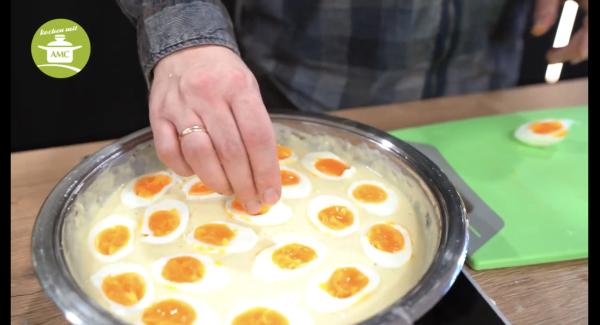Die geschälten Eierhälften in die Soße legen und noch einmal kurz aufkochen und ziehen lassen.